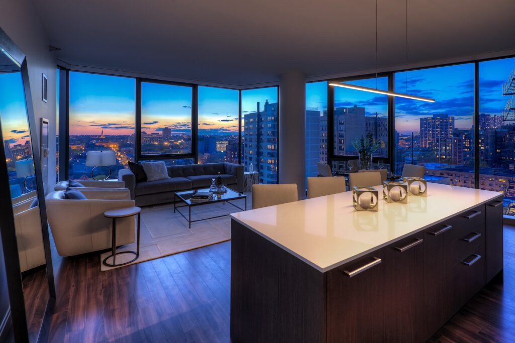 Sunset city view of Chicago through the kitchen and living room of a unit with floor to ceiling windows